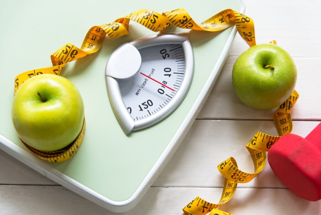 Dietitian,lifestyle,use,green,apple,prevention,fat,with,weight,scale
