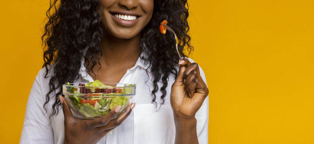 Smiling African American Girl Eating Vegetable Salad